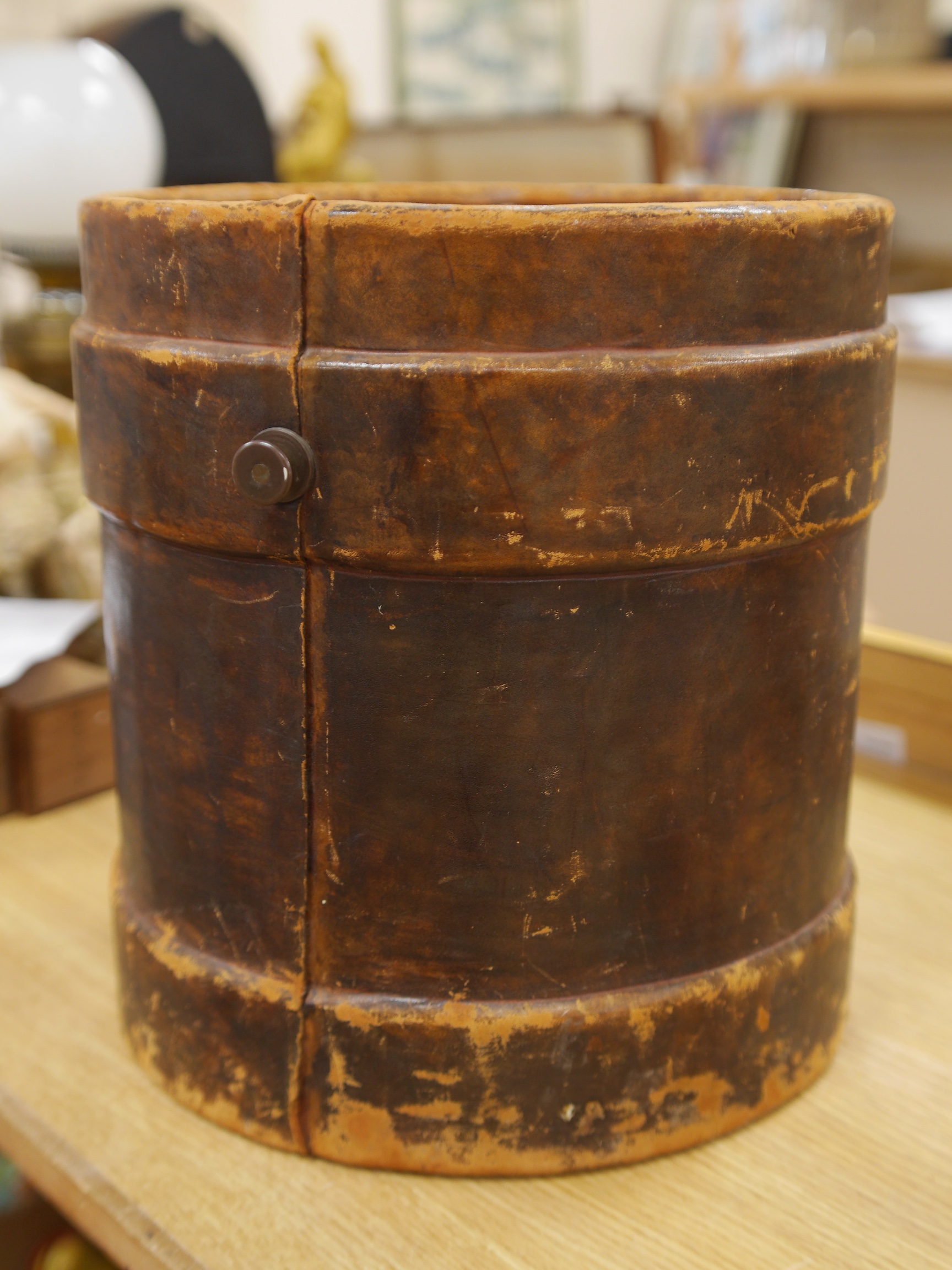 A 19th century leather fire bucket decorated with the Royal armorials, 36cm high. Condition - fair, some scuffing